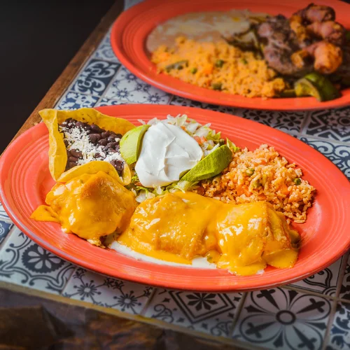 Pollo Fundido - Crispy fried chicken burrito smothered in cheese sauce